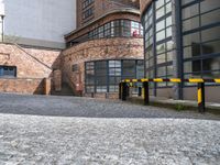 an empty parking area next to the sidewalk near buildings with signs on it that say