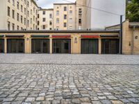 an empty parking garage in a city courtyard area on a cloudy day by a building