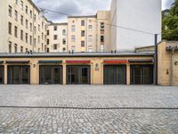 an empty parking garage in a city courtyard area on a cloudy day by a building