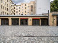 an empty parking garage in a city courtyard area on a cloudy day by a building