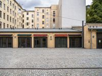 an empty parking garage in a city courtyard area on a cloudy day by a building