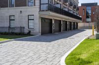 a bricked driveway in front of a large building and a fire hydrant in the middle of it