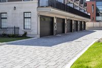 a bricked driveway in front of a large building and a fire hydrant in the middle of it