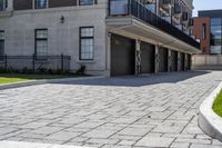 a bricked driveway in front of a large building and a fire hydrant in the middle of it