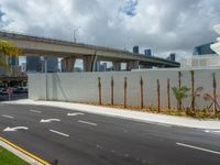 a freeway is shown passing a building and palm trees on the other side of it