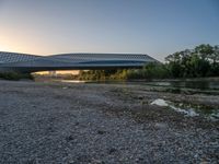 there are two very long bridges that are above the river shore at dusk here, and you can see how close them are