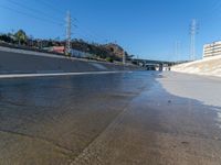 an urban roadway filled with puddles of water on the side of the street and on the side