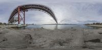 the reflection of an image of a bridge in water near a body of water at daytime