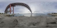 the reflection of an image of a bridge in water near a body of water at daytime