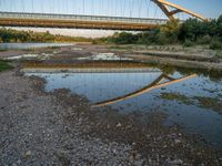 there are two very long bridges that are above the river shore at dusk here, and you can see how close them are