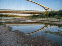 there are two very long bridges that are above the river shore at dusk here, and you can see how close them are