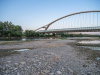 there are two very long bridges that are above the river shore at dusk here, and you can see how close them are