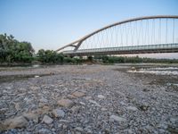 there are two very long bridges that are above the river shore at dusk here, and you can see how close them are