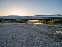 there are two very long bridges that are above the river shore at dusk here, and you can see how close them are