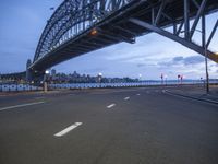 an image of a bridge over the road and buildings in the background in an empty lot