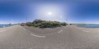 the 360 - view shows two traffic cameras as it passes a bridge and trees near water