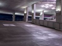 a building is lit up by bright led lights and railings over an empty parking space