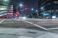 a night view of the intersection at a busy intersection, looking at some buildings and red lights