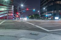 a night view of the intersection at a busy intersection, looking at some buildings and red lights