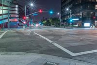 a night view of the intersection at a busy intersection, looking at some buildings and red lights