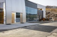 a building is being built and it looks very empty with machinery next to the building