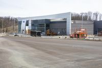 a building with an open area near a construction crane in front of it for work