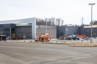 a building with an open area near a construction crane in front of it for work