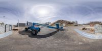 a picture taken through the side of a self - standing crane in a yard with a circular mirror