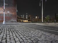 night view of brooklyn, new york skyline with street lights and brick sidewalk and steps