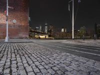 night view of brooklyn, new york skyline with street lights and brick sidewalk and steps