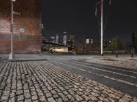 night view of brooklyn, new york skyline with street lights and brick sidewalk and steps