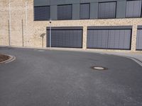 the building is made of brown brick walls and has street signs on it's side