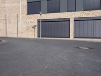 the building is made of brown brick walls and has street signs on it's side