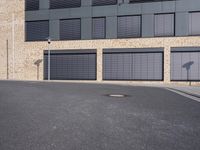 the building is made of brown brick walls and has street signs on it's side