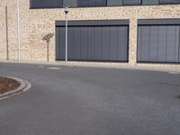 the building is made of brown brick walls and has street signs on it's side