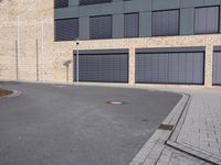 the building is made of brown brick walls and has street signs on it's side