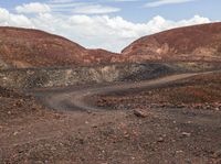 a very barren area with no people in it, with a few hills in the background