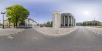 this street view shows a circular building and trees and buildings around it that is a full view on a google glass