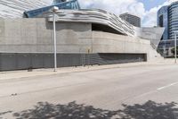 a long cement building with a staircase up the side and stairs down the front of it