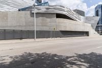 a long cement building with a staircase up the side and stairs down the front of it