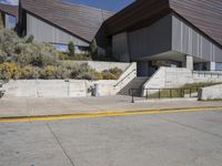 the stairs lead down to this building with an open air stair that leads to the entrance and entrance