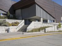 the stairs lead down to this building with an open air stair that leads to the entrance and entrance