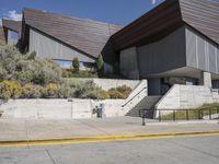 the stairs lead down to this building with an open air stair that leads to the entrance and entrance