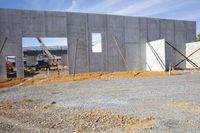 a cement slab and some construction materials are going up inside the building while a fork sits in it