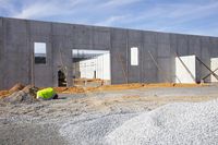 a cement slab and some construction materials are going up inside the building while a fork sits in it