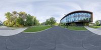 360 view of a building with an outside area with grass and trees on both sides of it