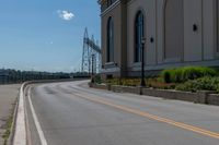 a side of a building on a highway and next to a yellow line of traffic