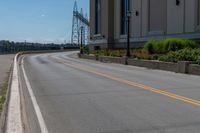 a side of a building on a highway and next to a yellow line of traffic