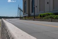 a side of a building on a highway and next to a yellow line of traffic