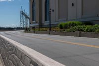 a side of a building on a highway and next to a yellow line of traffic